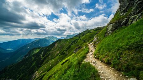 Mountain Pathway Under a Vibrant Sky wallpaper