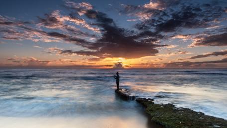 Fishing at Sunrise by the Shore wallpaper