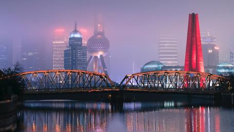 Misty Cityscape with Illuminated Bridge and Skyline wallpaper