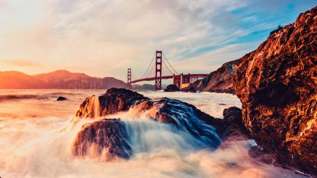 Golden Gate Sunset Over Rocky Shores wallpaper