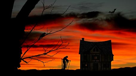 Haunted Silhouettes Against Twilight Sky wallpaper