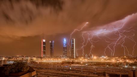 Striking Skyscrapers in a Stormy Night Sky wallpaper