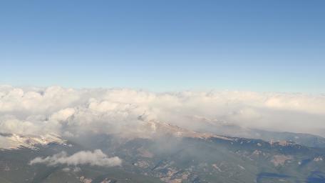 Majestic Clouds Over Mountain Peaks wallpaper