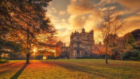 Golden Sunset Over Historic Castle Grounds wallpaper