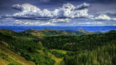 Breathtaking Mountain Landscape Under Dramatic Skies wallpaper