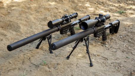 Tactical Precision Elite Sniper Rifles Displayed Outdoors wallpaper