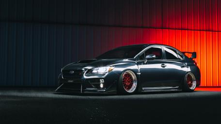 Subaru WRX STI Under Vibrant Lights wallpaper