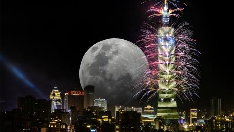 Majestic Cityscape Under a Full Moon wallpaper