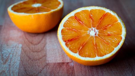 Citrusy Delight Freshly Cut Orange Wallpaper wallpaper