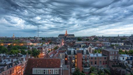 Majestic Cityscape Under Dramatic Clouds wallpaper