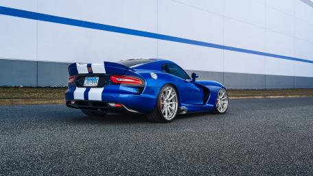 Sleek Blue Sports Car on a Road Surface wallpaper