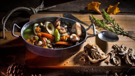 Hearty Vegetable Soup in a Rustic Setting wallpaper