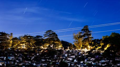 Star Trails Over a City Cemetery at Night wallpaper