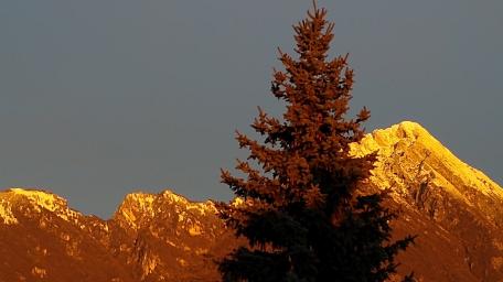 Majestic Winter Sunset Over Snowy Mountains wallpaper