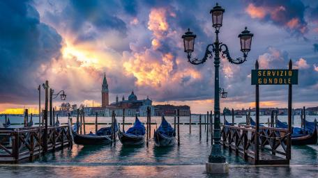 Venetian Sunset with Gondolas and Luminous Clouds wallpaper