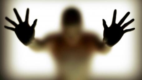 Hands silhouette behind glass wallpaper