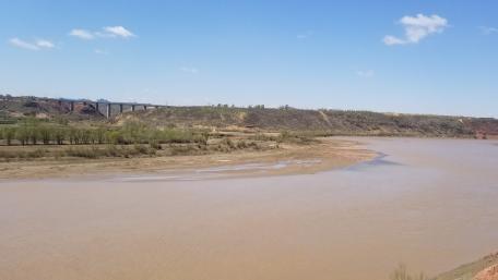 Serene River Landscape Under a Blue Sky wallpaper