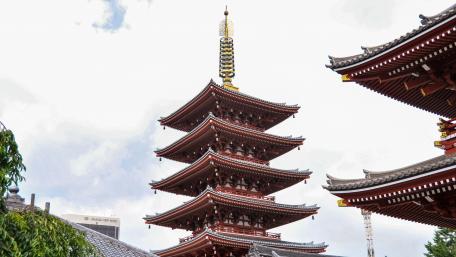 Serene Pagoda amidst Urban Landscape in 4K wallpaper