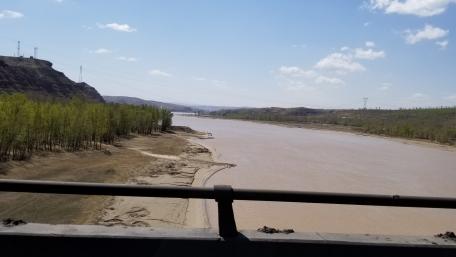 Serene River Landscape Under a Blue Sky wallpaper