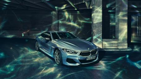 Sleek Blue BMW Illuminated by Artistic Light Patterns wallpaper