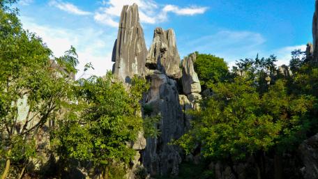 Majestic Rock Formations Surrounded by Lush Greenery wallpaper