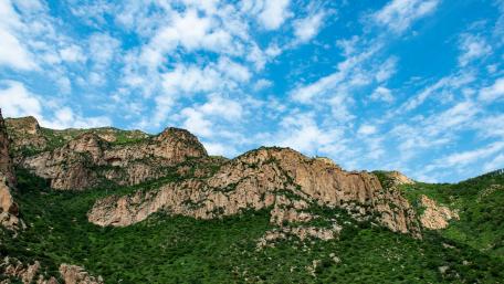 Majestic Mountain Peaks Under Bright Blue Sky wallpaper