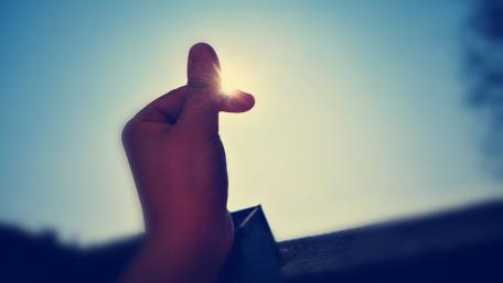 Fingers Reaching for the Sun in 4K Clarity wallpaper