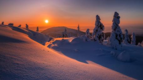 Serene Winter Sunset Over Snowy Landscape wallpaper