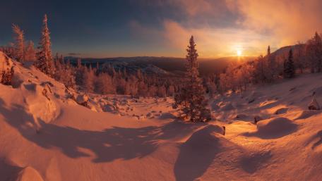 Serene Winter Sunset Over Snowy Landscape wallpaper