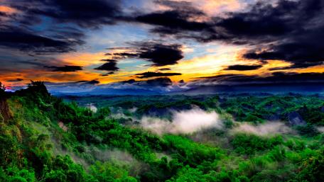 Majestic Sunset Over Lush Green Mountains wallpaper