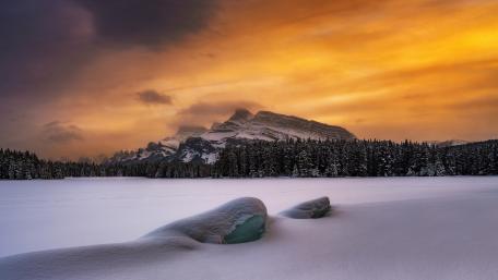 Majestic Winter Sunrise over Snowy Landscape wallpaper