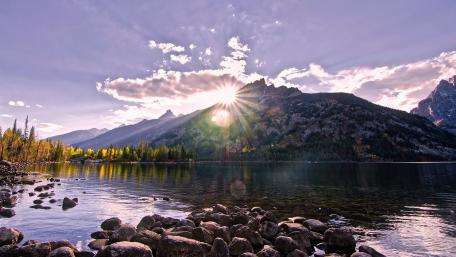 Majestic Mountain Sunrise Over Tranquil Lake wallpaper
