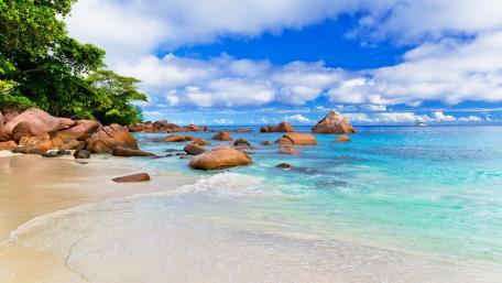 Serene Summer Beach with Boulders and Ocean Waves wallpaper