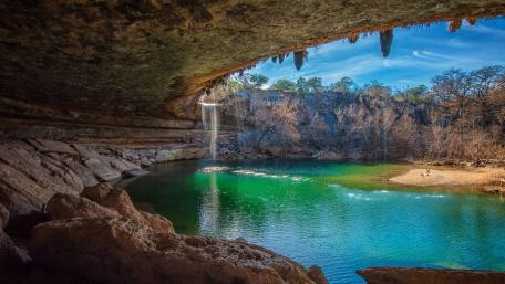 Stunning Cave Waterfall Surrounded by Nature wallpaper