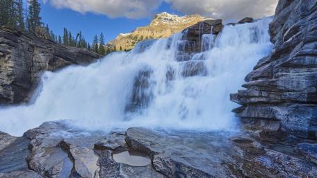 Majestic Waterfall Cascading Over Rocks wallpaper