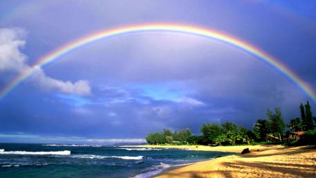 Vibrant Rainbow Over Serene Beach Scene wallpaper