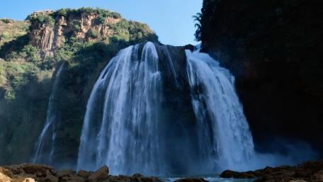 Majestic Waterfall Surrounded by Nature wallpaper