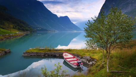 Serene Norwegian Fjord with Tranquil Boat Scene wallpaper