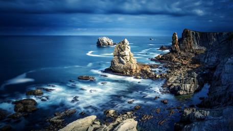 Majestic Sea Stacks Under Cloudy Sky wallpaper