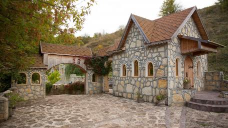 Charming Stone Cottage in Serene Landscape wallpaper