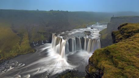 Majestic Waterfall Amidst Nature's Serenity wallpaper