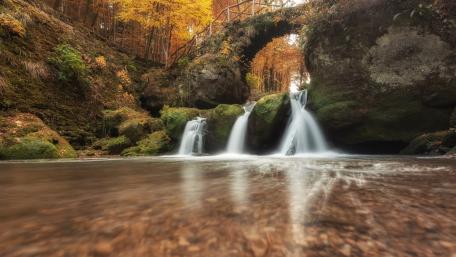 Enchanting Autumn Waterfall Scene wallpaper