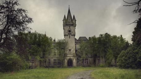 Mystical Castle Amidst Lush Greenery wallpaper
