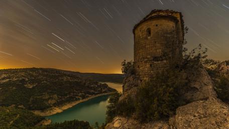 Mystical Star Trails Over Ancient Fortress wallpaper