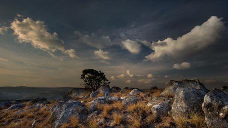 Serene Landscape with Majestic Clouds and Rocks wallpaper