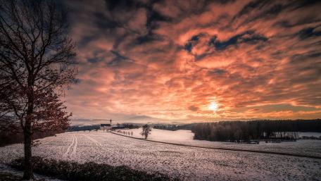 Serene Winter Sunset Over Snowy Landscape wallpaper