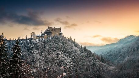Majestic Castle Amidst Snowy Peaks wallpaper
