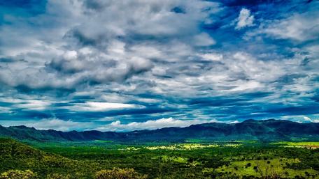 Majestic Sky Over Lush Green Landscape wallpaper