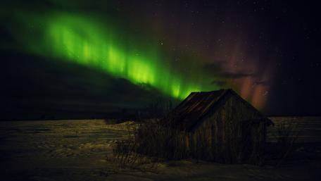Aurora Borealis Over a Cozy Cottage Night Sky Scene wallpaper