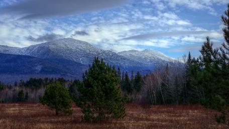 Majestic Mountain Landscape Under a Cloudy Sky wallpaper